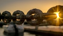 Chain links with sun shining through