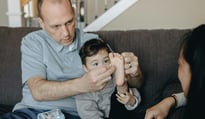 parents bandaging a child's foot